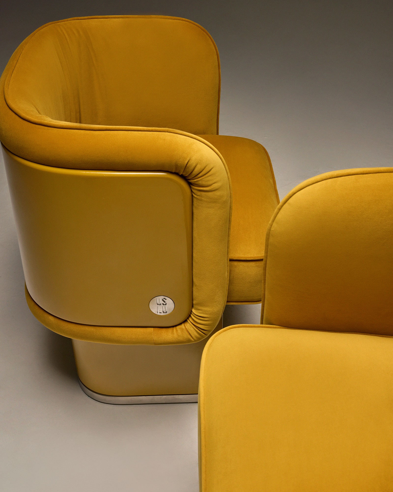The Unifier Dining Chair and Armchair, curved velvet armrest and stainless steel badge