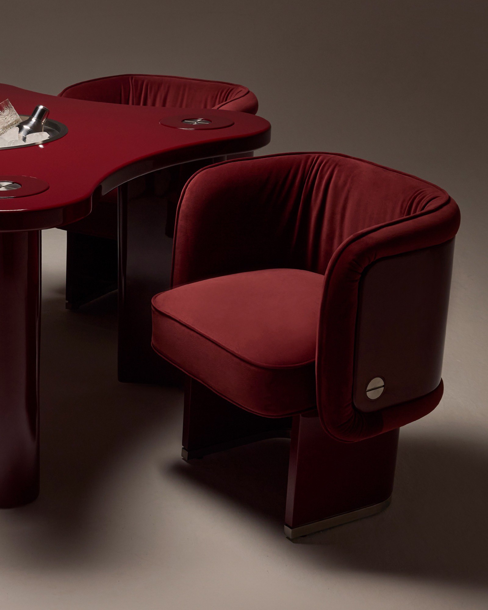 The Unifier Dining Chair and Armchair in bordeaux velvet, three quarter view