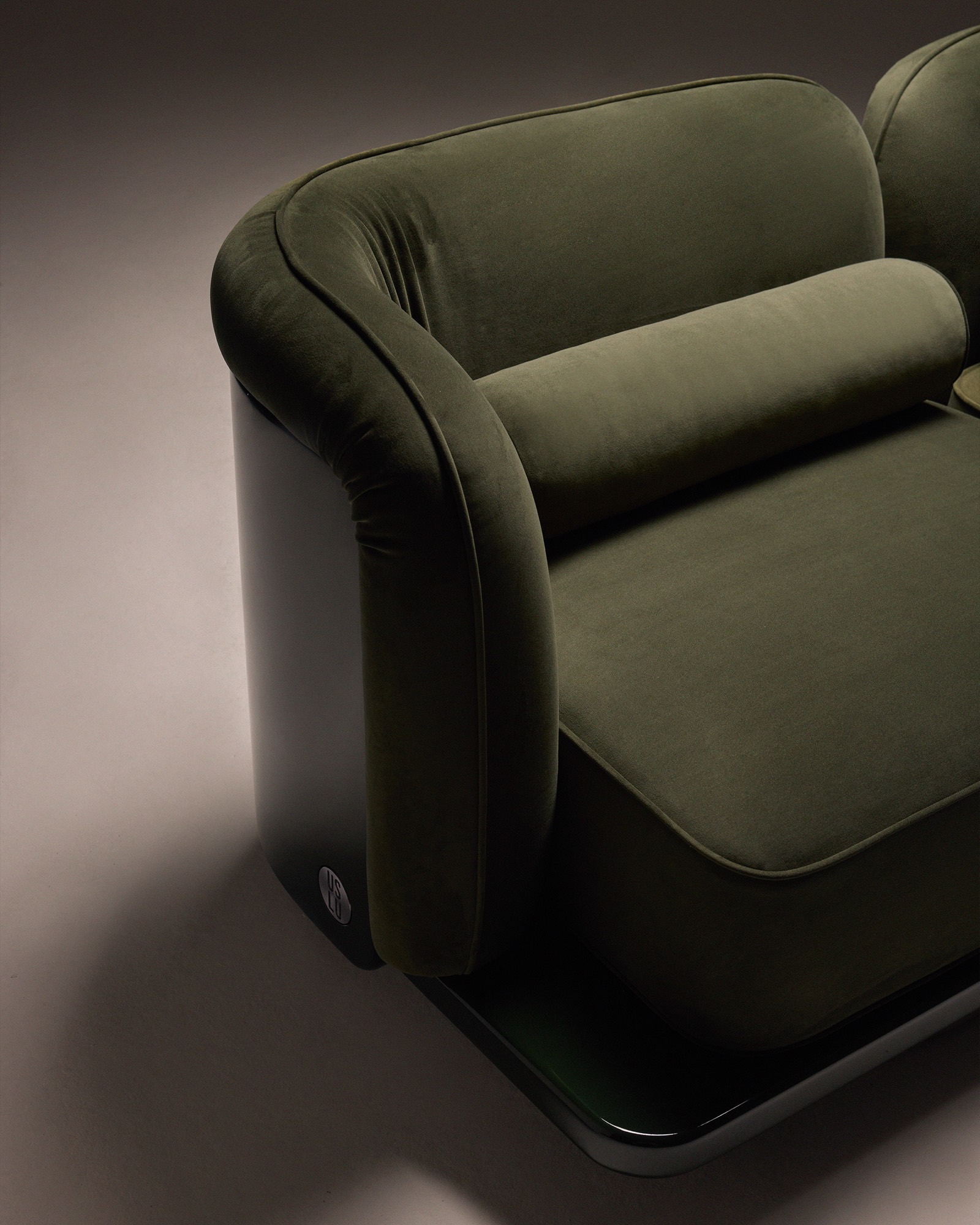 The Whisper Two-Seater Sofa, armrest and lacquered side with stainless steel badge