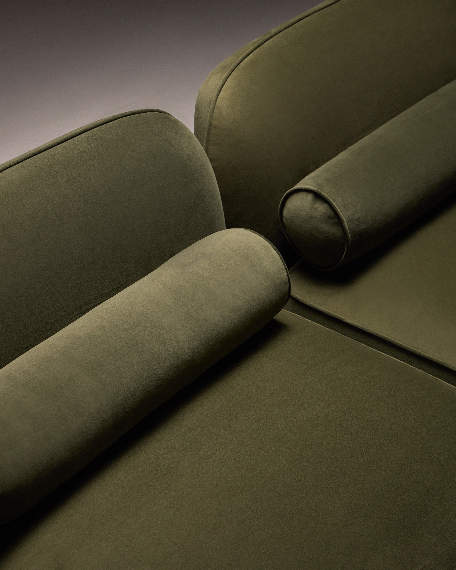 The Whisper Two-Seater Sofa, velvet bolster cushions detail