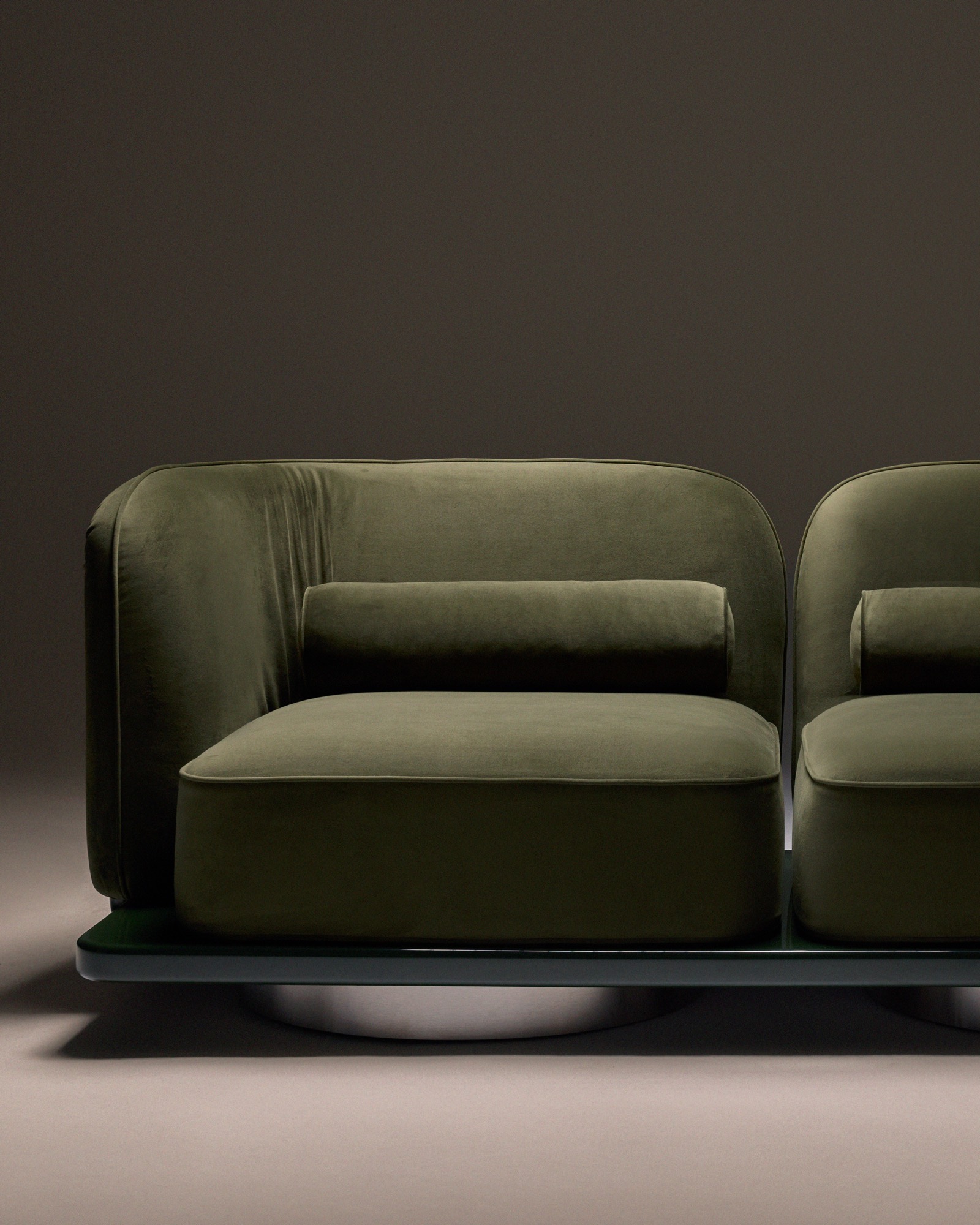 The Whisper Two-Seater Sofa, front view on its lacquered base